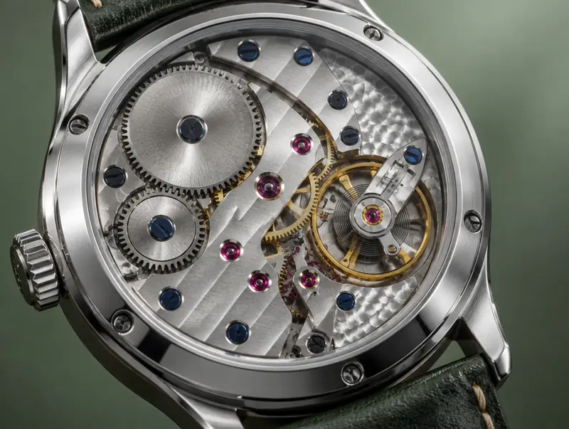Close-up of a mechanical watch movement showing gears, jewels and balance wheel